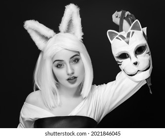 Blonde Girl In A Wig On A Black Background With Cosplay Mask, Cat Woman.