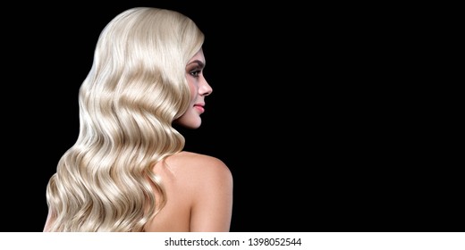 Blonde  Hair Portrait With Blue Eyes And Healthy Long Shiny Wavy Hairstyle Posing On Black Background. Volume Shampoo. Blond Curly Permed Hair And Bright Makeup.  Beauty Salon And Haircare Concept.