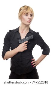 blonde haired business woman holding a gun up to her chest