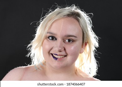 Blonde Haired Plus Size Woman On A Black Background With Makeup On Half Of Her Face And No Makeup On The Other Face