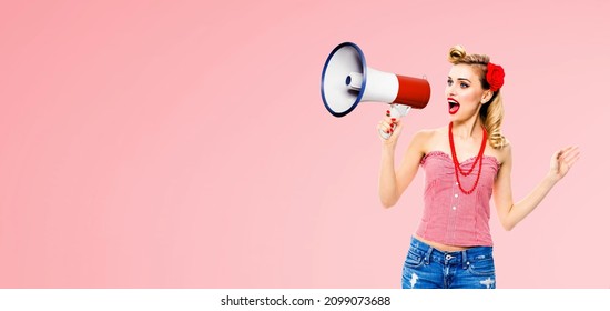 Blonde Haired Woman Holding Mega Phone, Shout Advertise Something. Girl In Red Pin Up Style, Isolated Over Rose Pink Color Back. Female Model In Retro Vintage Studio Sales Rebated Discounts Ad Concept