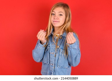 Blonde Little Kid Girl Wearing Denim Jacket Over Red Background  Doing Money Gesture With Hands, Asking For Salary Payment, Millionaire Business