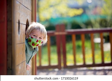 Blonde Little Toddler Child Inwearing Protective Mask, Playing On The Playground, Spring Sunny Day