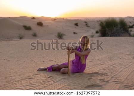 Blonde model in the desert at Emirates