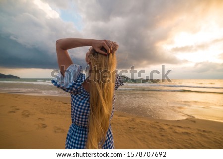 Blonde model on the beach at sunset