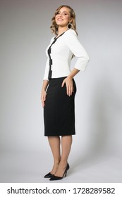 blonde model posing in white jacket and black skirt 