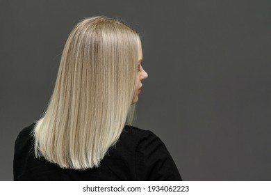Blonde model with straight hair, look from behind. Hair bleaching result. Space for text - Shutterstock ID 1934062223