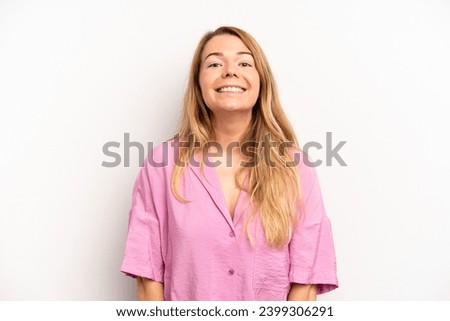 blonde pretty woman looking happy and goofy with a broad, fun, loony smile and eyes wide open