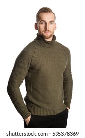 Blonde Smiling Man Wearing A Green Turtle Neck Sweater Standing Against A White Background Feeling Great.