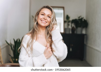 Blonde Smiling Woman 35 Year Clean Fresh Face And Hands With Long Hair In Cozy Knitted Cardigan At The Bright Interior