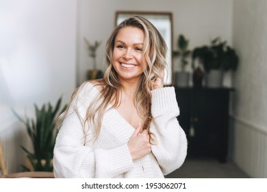 Blonde Smiling Woman 35 Year Clean Fresh Face And Hands With Long Hair In Cozy Knitted Cardigan At The Bright Interior