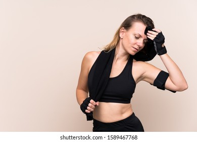 Blonde sport woman over isolated background with sport towel