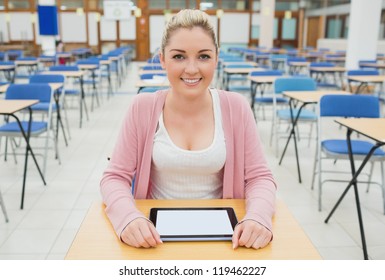 Blonde Student With Tablet Pc Sitting In Exam Hall