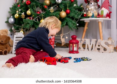 Blonde Toddler Boy, Playing With Car Toys On Christmas