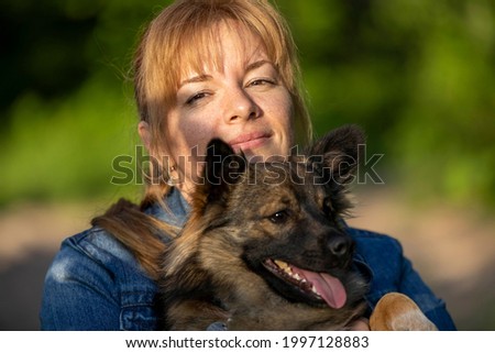 Similar – Pretty blond woman with her two dogs