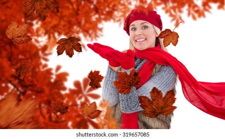 Blonde In Winter Clothes With Hands Out Against Autumn Leaves Pattern