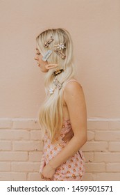 Blonde Woman With Acrylic And Pearl Clips In Her Hair, Model Wearing Resin Hair Barrettes, Modern Hair Pins On Girl, Pink Brick Wall Background