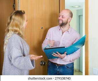 Blonde Woman Answer Questions Of Outreach Worker With Paper In Home Door