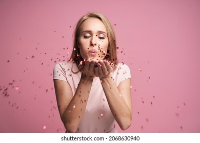 Blonde Woman Blowing Little Heart Shaped Confetti