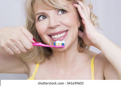 Blonde Woman Brushing Teeth