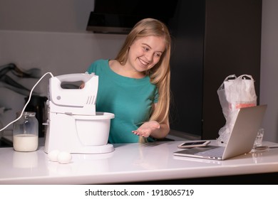 A Blonde Woman Chef Videoblogger Cooking In The Kitchen And Filming, Online Learning Or Remote Cooking Class Concept. Streaming Live Video. Cooking Tutorial