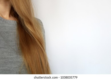 a blonde woman is doing her hairdo, decomposed, combing,  straightens the disheveled bun on her head. Modern fast hairstyle. The concept of hair care.  Cares about a beautiful hair.  Copyspace - Shutterstock ID 1038035779