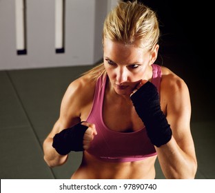 Blonde Woman Doing Martial Arts Workout In A Gym