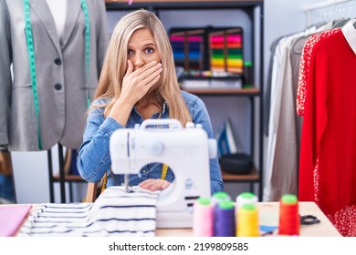 Blonde Woman Dressmaker Designer Using Sew Machine Shocked Covering Mouth With Hands For Mistake. Secret Concept. 