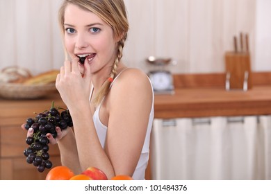 Blonde Woman Eating Grapes