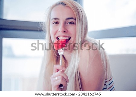 Similar – Image, Stock Photo Young and blonde woman holding a strawberry ice cream