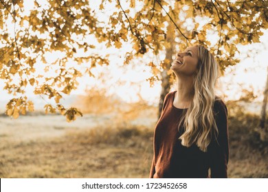 Blonde Woman Enjoys The Autumn