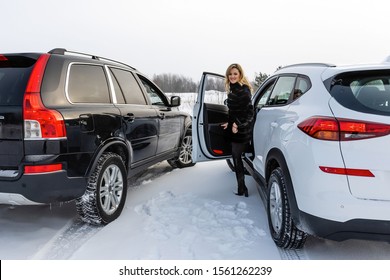 The blonde woman gets out of the white suv car and looks back. - Powered by Shutterstock