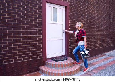 Blonde Woman Going Out On Weekend Healthy Recreation Wearing Jeans.Pretty Urban Middle Age Female Go For Driving Roller Skates.Going Home After Roller Skating,opening The Home Door