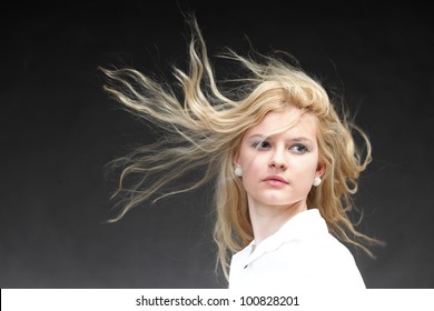 Blonde Woman With Her Hair Blowing In The Wind