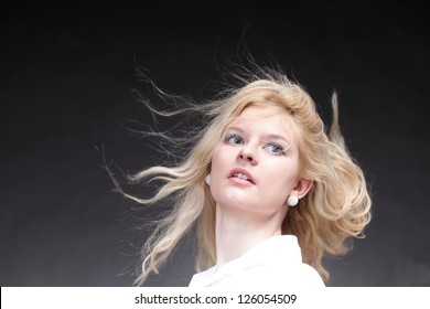 Blonde Woman With Her Hair Blowing In The Wind