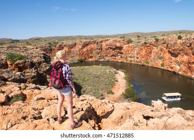 Blonde Woman Hiking In Outback Australia, At Yardie Creek River Lookout In Cape Range National Park, Exmouth, Summer Sunny Blue Sky, Boat, Copy Space.