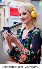 Blonde woman listening to music whit a mobile