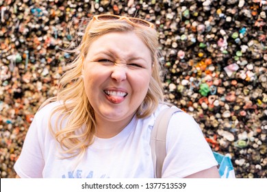 Blonde Woman Makes A Gross Face With Her Tounge Out While Visiting The Bubblegum Alley Wall In San Luis Obispo California