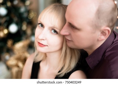 Blonde woman and a man in a New Year decor