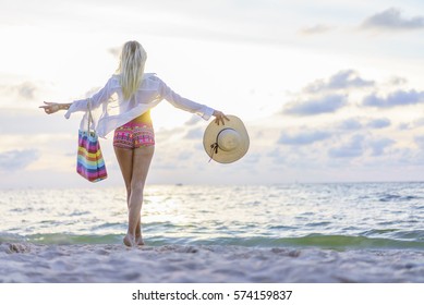 Blonde Woman On The Beach At Sunset