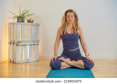 Blonde Woman On Mat In Lotus Position At Yoga School - Meditation And Focus Mindfulness Concept