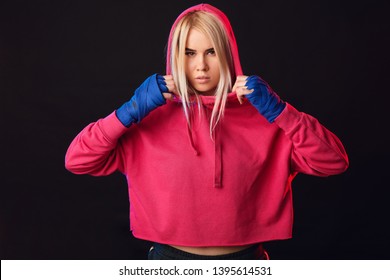 Blonde Woman In Pink Hoodie And Black Shorts Perfecting Moves And Kicks On Mixed Martial Arts Classes At Gym.