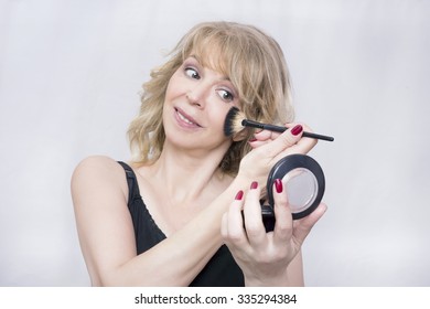 Blonde Woman Putting On Makeup