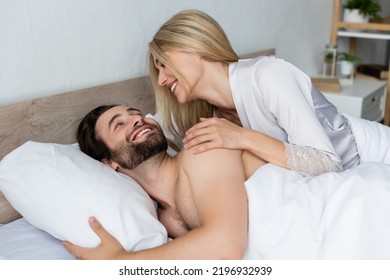 Blonde Woman In Robe Waking Happy Bearded Man In Morning