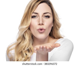 Blonde woman sending air kiss over white background