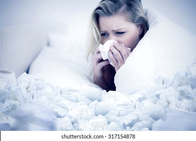 Blonde Woman Sneezing Against Used Tissues