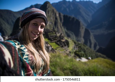 Blonde Woman Standing On A Mountain In Machu Picchu Smiling At The Camera Sin A Selfie