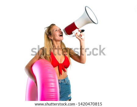 Blonde woman in summer vacation holding a megaphone on isolated white background