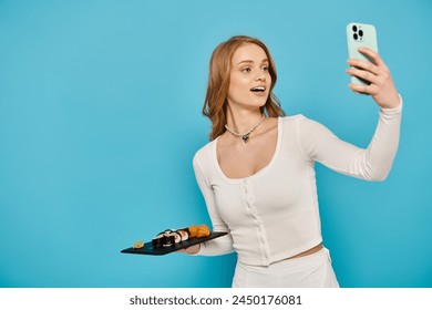 Blonde woman taking a selfie with her cell phone while holding delicious Asian food, striking a pose. - Powered by Shutterstock