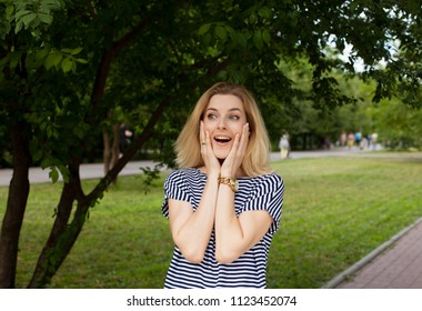 Blonde Woman Unexpecting Meet Someone In Park. Happy To See Old Frends.